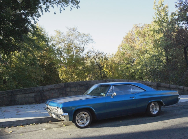 Car parked on bridge (Bronx Blvd.) going over river.  River and parkway in backg
